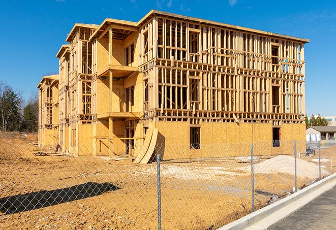 a close-up of temporary chain link fences enclosing a job site, signaling progress in the project's development in Farmington